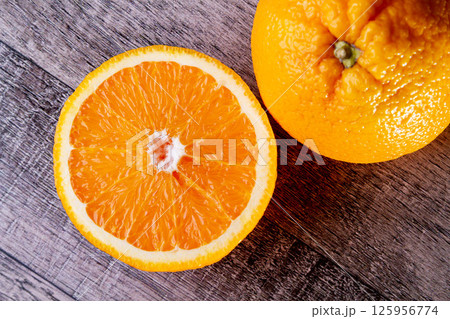 Two halves of an orange top view. Preparation of freshly squeezed juice. Copyspace. Two halves of an orange top view. Preparation of freshly squeezed juice. Copyspace. 125956774