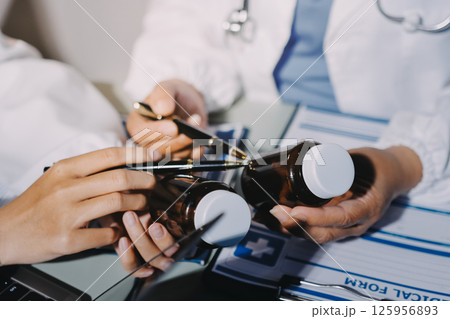 Male and female doctors are having a meeting in a hospital room. Male and female doctors are having a meeting in a hospital room. 125956893