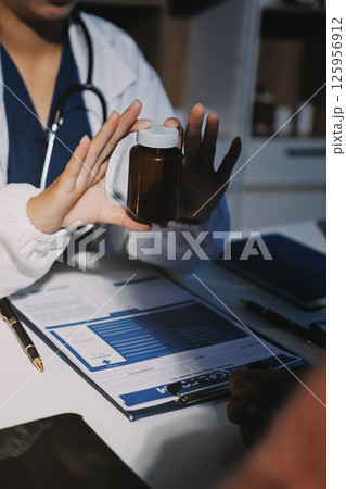 Specialized doctor is explaining taking medicine to a patient. Health and medicine consultation. Specialized doctor is explaining taking medicine to a patient. Health and medicine consultation. 125956912