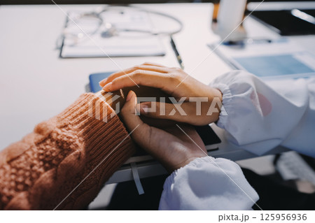 Asian female hands touching old female hand Helping hands take care of the elderly concept in hospital. 125956936