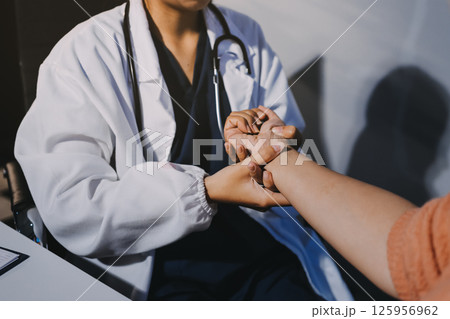 Orthopedist examining patient in hospital Orthopedist examining patient in hospital 125956962