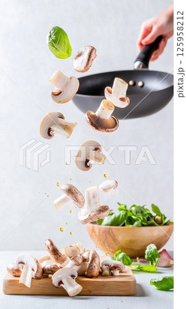 Motion capture of wild mushrooms in oil, creating a vibrant culinary moment Motion capture of wild mushrooms in oil, creating a vibrant culinary moment 125958212