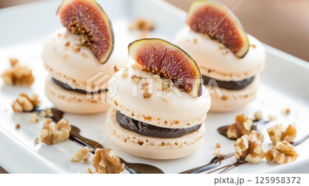 Delightful French Macaroons with Fig Topping and Chocolate Filling Served on a White Plate Surrounded by Nuts and Drizzled Sauce for a Gourmet Dessert Experience Delightful French Macaroons with Fig Topping and Chocolate Filling Served on a White Plate Surrounded by Nuts and Drizzled Sauce for a Gourmet Dessert Experience 125958372