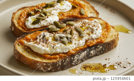 Toasted bread slathered with pumpkin puree, creamy ricotta, sprinkled with pumpkin seeds, drizzled olive oil, dusted cinnamonnutritious autumn inspired toast Toasted bread slathered with pumpkin puree, creamy ricotta, sprinkled with pumpkin seeds, drizzled olive oil, dusted cinnamonnutritious autumn inspired toast 125958601