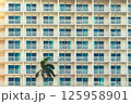 Modern hotel with rows of balconies creates a geometric pattern. 125958901