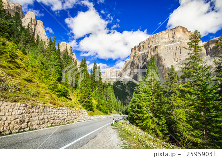 Dolomites, Italy. Sella Ronda mountain ridge and winding road to Sella Pass 125959031
