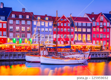 Copenhagen, Denmark. Nyhavn, Kobenhavn's iconic canal, colorful night water reflection. 125959032