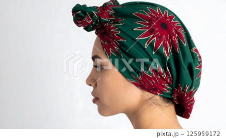 A woman wearing a green and red flowery head scarf 125959172