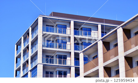 Modern new residential apartment house building complex. Exterior view of modern apartment building. New construction apartment or condo complex. 125959414