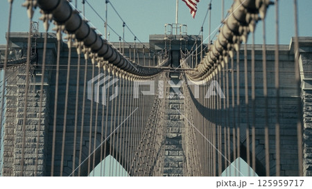 American flag waving over Brooklyn Bridge in Manhattan, New York 125959717
