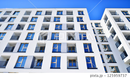 Modern new residential apartment house building complex. Exterior view of modern apartment building. New construction apartment or condo complex. Modern new residential apartment house building complex. Exterior view of modern apartment building. New construction apartment or condo complex. 125959737