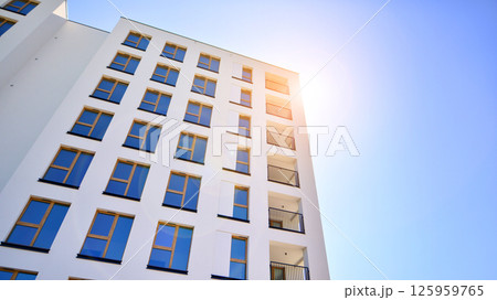 Modern new residential apartment house building complex. Exterior view of modern apartment building. New construction apartment or condo complex. 125959765