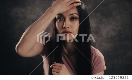Woman Expressing Thoughtful Emotion with Hand Gesture Woman Expressing Thoughtful Emotion with Hand Gesture 125959821