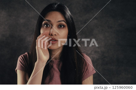 Young woman whispering gossiping sharing secrets with hand near mouth Young woman whispering gossiping sharing secrets with hand near mouth 125960060