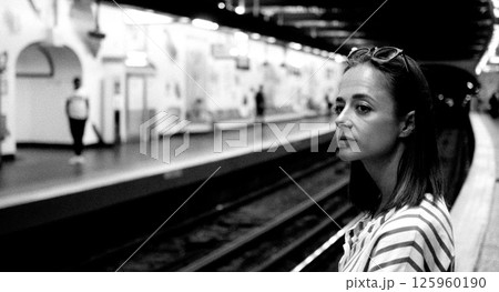 Young woman waiting for subway train in Paris metro station 125960190