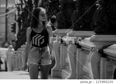 Young woman walking on Alexandre III bridge in Paris Young woman walking on Alexandre III bridge in Paris 125960220