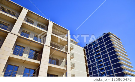 Modern new residential apartment house building complex. Exterior view of modern apartment building. New construction apartment or condo complex. Modern new residential apartment house building complex. Exterior view of modern apartment building. New construction apartment or condo complex. 125960476