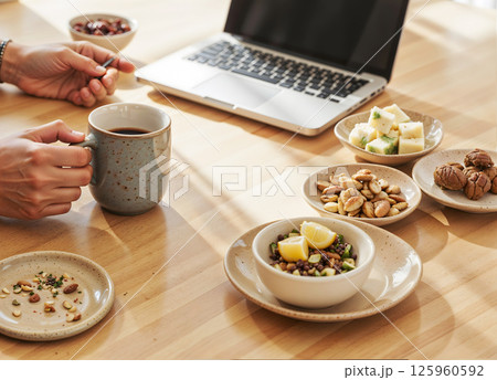 A Deliciously Healthy Breakfast and a Productive Work Setup Arranged on a Wooden Table 125960592