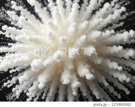 Dramatic fluffy white smoke explosion burst with trailing wisps on dark black background 125960982