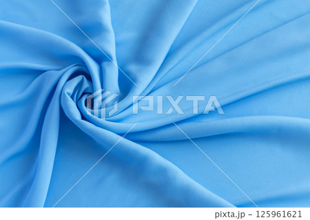 Vivid twisted plain light blue fabric cloth texture close up 125961621