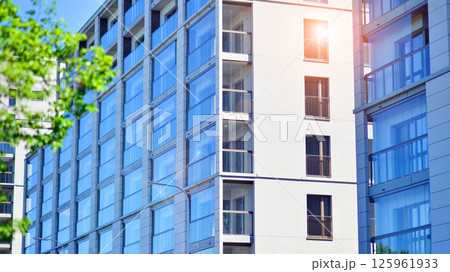 Eco apartment building saving energy and fresh air. Modern block of flats in green area, residential apartment and luxury house complex.  125961933