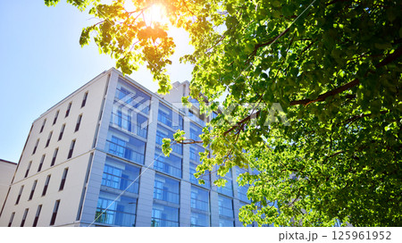 Eco apartment building saving energy and fresh air. Modern block of flats in green area, residential apartment and luxury house complex.  125961952