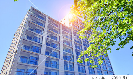 Eco apartment building saving energy and fresh air. Modern block of flats in green area, residential apartment and luxury house complex.  125961953