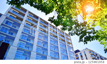 Eco apartment building saving energy and fresh air. Modern block of flats in green area, residential apartment and luxury house complex.  125961958