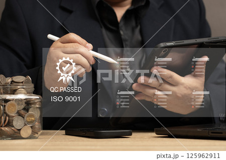 Quality Assurance in Financial Investments and Business Services. man reviewing quality control checklists on a tablet, ensuring service excellence and customer satisfaction. QC PASSED ISO 9001. Quality Assurance in Financial Investments and Business Services. man reviewing quality control checklists on a tablet, ensuring service excellence and customer satisfaction. QC PASSED ISO 9001. 125962911