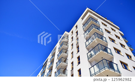 Modern new residential apartment house building complex. Exterior view of modern apartment building. New construction apartment or condo complex. 125962982