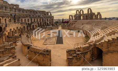 Entrance to ancient african Roman Colosseum amphitheatre arena panorama with ruins and columns, in subset time El Jem, Mahdia, Tunis 125963903