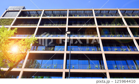 Modern city eco office building with tree. Detail shot of modern architecture facade,business concepts. Environment. Modern building and trees, double exposure. 125964410