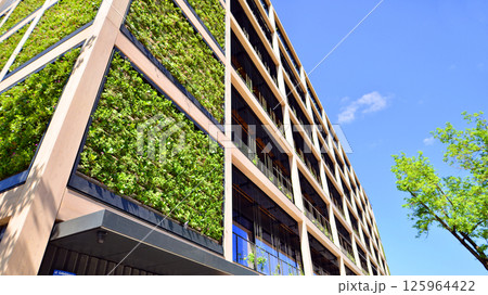 Modern city eco office building with tree. Detail shot of modern architecture facade,business concepts. Environment. Modern building and trees, double exposure. 125964422
