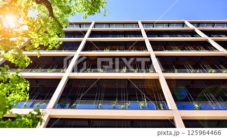 Modern city eco office building with tree. Detail shot of modern architecture facade,business concepts. Environment. Modern building and trees, double exposure. Modern city eco office building with tree. Detail shot of modern architecture facade,business concepts. Environment. Modern building and trees, double exposure. 125964466