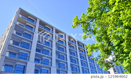 Eco apartment building saving energy and fresh air. Modern block of flats in green area, residential apartment and luxury house complex. Eco apartment building saving energy and fresh air. Modern block of flats in green area, residential apartment and luxury house complex. 125964602