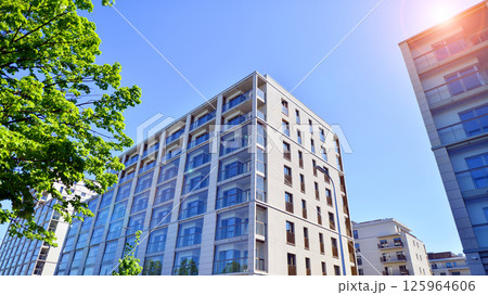 Eco apartment building saving energy and fresh air. Modern block of flats in green area, residential apartment and luxury house complex.  125964606