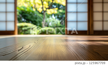 serene Japanese style room with wooden floor, open sliding doors, and lush green garden view in soft sunlight serene Japanese style room with wooden floor, open sliding doors, and lush green garden view in soft sunlight 125967709