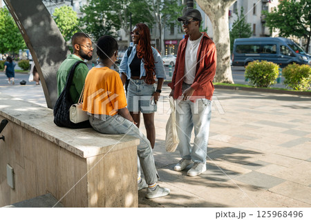 Smiling cheerful Black friends enjoying post exam downtime together. Friendly youth group having fun Smiling cheerful Black friends enjoying post exam downtime together. Friendly youth group having fun 125968496