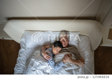 Love and understanding in long term relationship, couple sleeping hugging in bed, peaceful bonding Love and understanding in long term relationship, couple sleeping hugging in bed, peaceful bonding 125968816