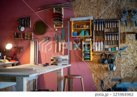 Professional carpenter workshop with tool cabinet and workbench for custom furniture creation 125968962
