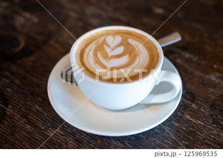 A cup of coffee with latte art, on the table 125969535