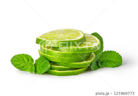 Stack of fresh lime slices with sprig of mint on white background 125969773