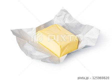 Wrapped butter block on white background: dairy product photography 125969820
