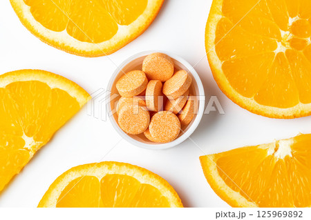 Orange effervescent tablets vitamins C on white background 125969892