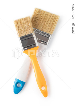 A white paintbrush with a blue handle. The brush is clean and ready to use. 125969907