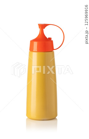 Yellow squeeze bottle with orange cap for sauces and condiments on white background Yellow squeeze bottle with orange cap for sauces and condiments on white background 125969916