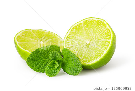 Fresh limes with mint leaves resting on white background 125969952