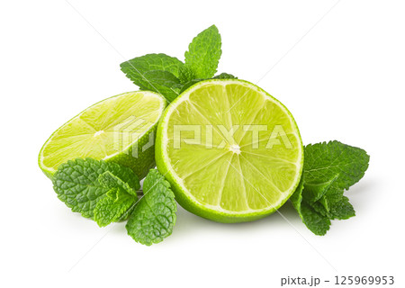Fresh limes with mint leaves resting on white background 125969953