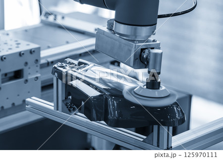 The automotive parts polishing process by robotic system in the light blue scene. 125970111