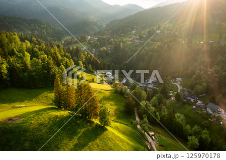 Calm idyllic village in Slovenian mountains at sunrise, summer travel concept Calm idyllic village in Slovenian mountains at sunrise, summer travel concept 125970178